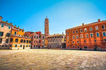 Venice cityscape, Campo S Anzolo square and leaning campanile church tower. Italy.