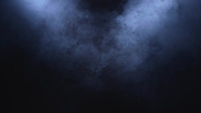 Smoke clears in the spotlight on black background