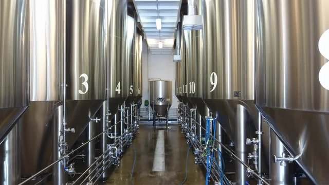 Modern Craft Brewery. Steel fermentation vessels. Shooting with drone.