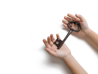 Children's hands hold aт old key  on white isolated