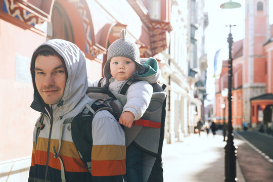 Father with child son in carrier backpack at old center of Ljubljana