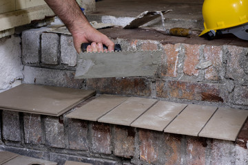 A workplace for a master from laying tiles. Tools and accessories as well as tiles when laying.