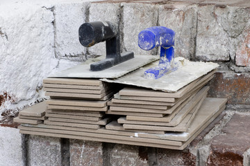 A workplace for a master from laying tiles. Tools and accessories as well as tiles when laying.