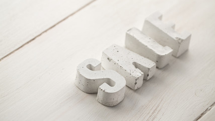 concrete letters on a wooden board