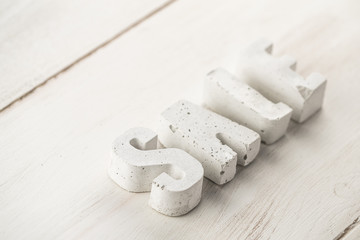 concrete letters on a wooden board