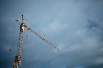 high crane on blue cloudy sky