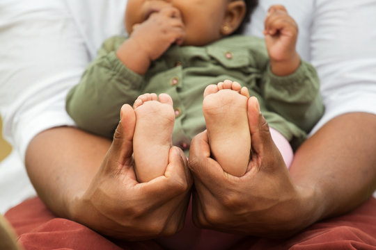 African American Father Holding His Daughters Feet.