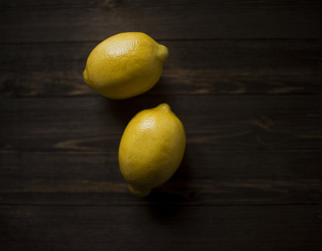 Overhead view of lemons on wooden table