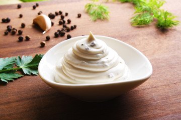 mayonnaise sauce on a wooden background cooking