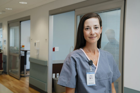 Portrait of confident nurse in hospital corridor