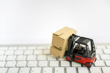 Miniature toy:Fork lift operator during lift product box  . Transportation ,Business,Logistic ,shopping on line concept.