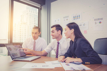 Fototapeta premium Business team having a meeting using laptop during a meeting and presents profit, Present report analysis and planning with brainstorm in teamwork.