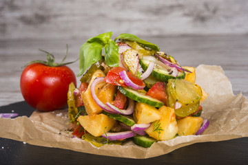 Delicious country salad with potatoes and cucumbers