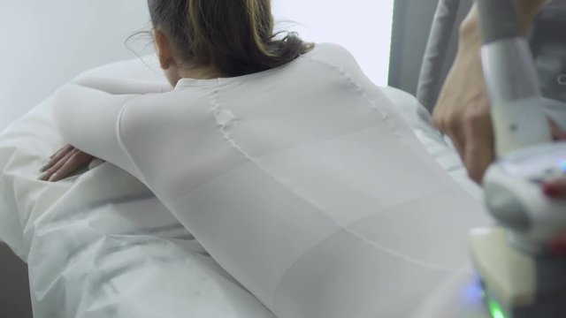 Doctor massages patient with lpg apparatus