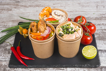 Soup of noodles with shrimps, seafood, chicken and vegetables. Asian cuisine. The udon noodles. Wok.