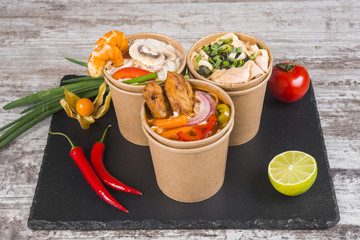 Soup of noodles with shrimps, seafood, chicken and vegetables. Asian cuisine. The udon noodles. Wok.