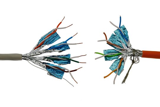 Two twisted pair STP network copper cables standing against each other.