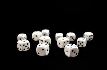 White dice with black dots stock photo images. Playing white dice with black dots isolated on a black background
