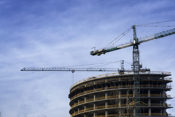 Fototapeta na wymiar tower crane at construction site in morning sunlight