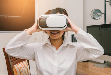 A woman wearing virtual reality enjoying and smiling in content, Innovation technology