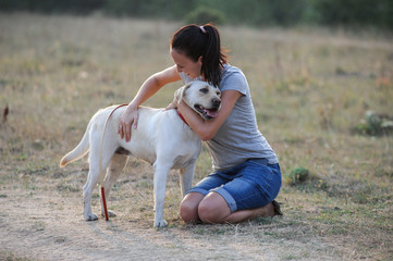 Woman and dog posing outdoor.