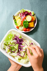 Hand holding fresh vegetables for mixed vegetables salad cooking
