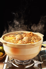 Cooking spicy hot pot boiling on the fire burning stove  