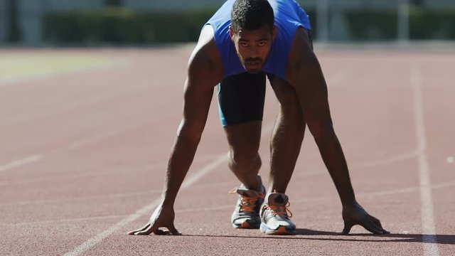 Professional runner starts his race from crouch start, desire to win, endurance
