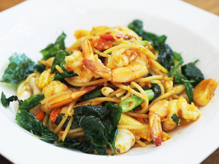 spicy spaghetti seafood on white plate
