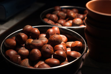 Roasted chestnuts on silver tray put on table in restaurant.