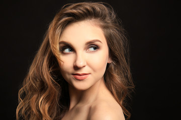 Fototapeta premium Attractive young woman with caramel highlights on black background