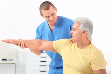 Physiotherapist working with patient in rehabilitation centre