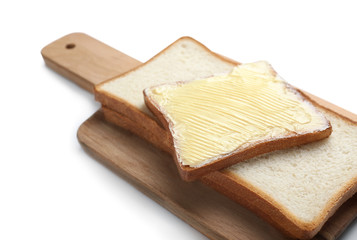 Board with tasty toasts and butter on white background, closeup