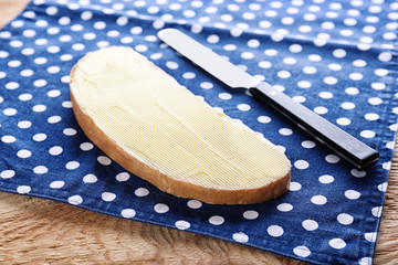 Piece of healthy bread with butter on table