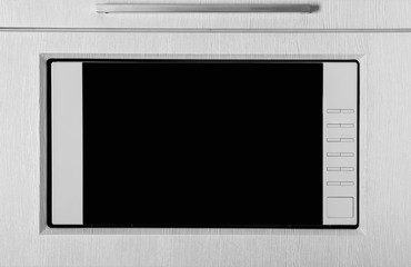 New white microwave oven in kitchen, closeup