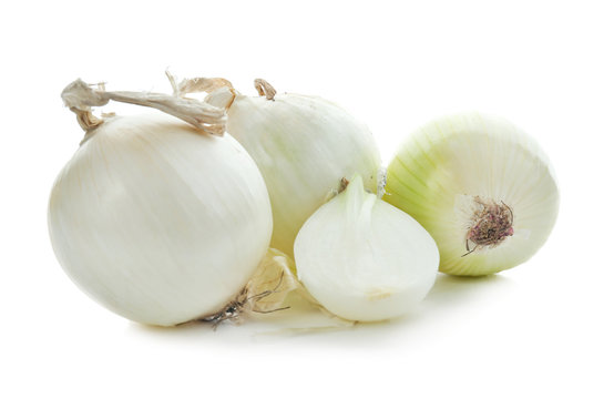Fresh whole and cut onions on white background