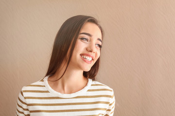 Portrait of beautiful smiling woman on color background