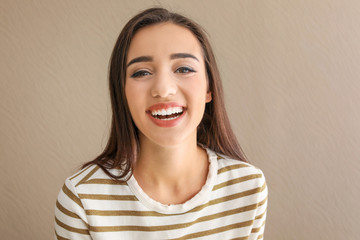 Portrait of beautiful smiling woman on color background