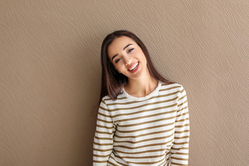 Portrait of beautiful smiling woman on color background