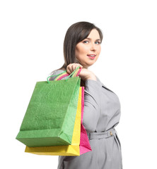 Beautiful overweight woman with shopping bags on white background