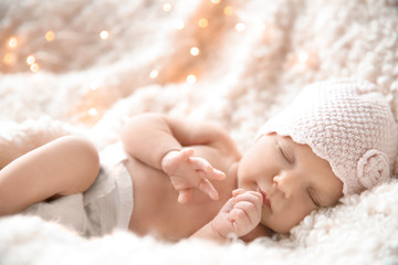 Cute newborn baby girl lying on plaid