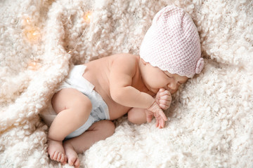 Cute newborn baby girl lying on plaid