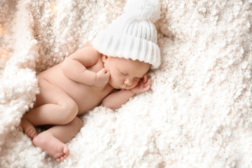 Cute newborn baby girl lying on plaid