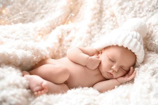 Cute newborn baby girl lying on plaid