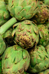 Fresh artichokes on display at the farmers' market for sale.