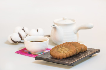 Korea traditional cookies on the dish. teapot. tea. cotton flower