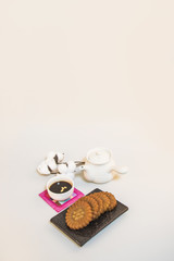 Korea traditional cookies on the dish. teapot. tea. cotton flower