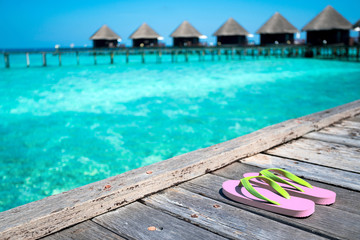 Fototapeta na wymiar Sandals on the beautiful beach - summer vacation