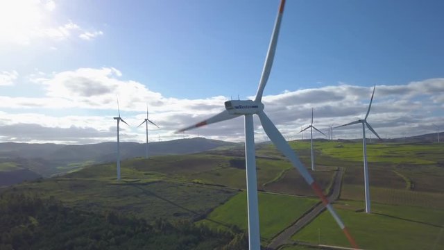 counter clockwise orbit close beside turbine in wind farm
