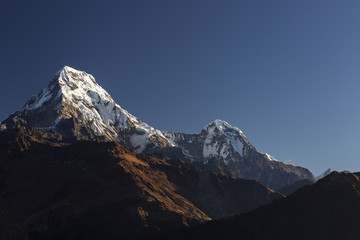 Fototapeta premium View of Annapurna South at sunset from Poon Hill with buddhist flags. Himalaya Mountains, Nepal